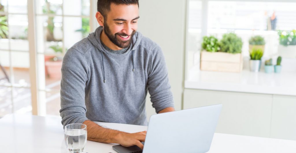 man learning languages online with lingoda using his laptop