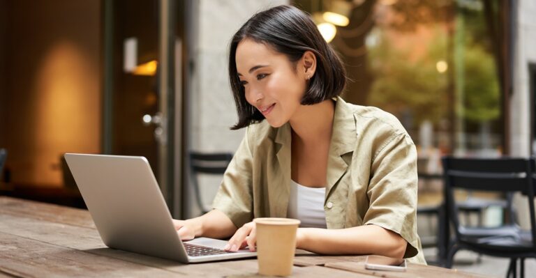 Young woman learning German looking up language levels from A1 to C2