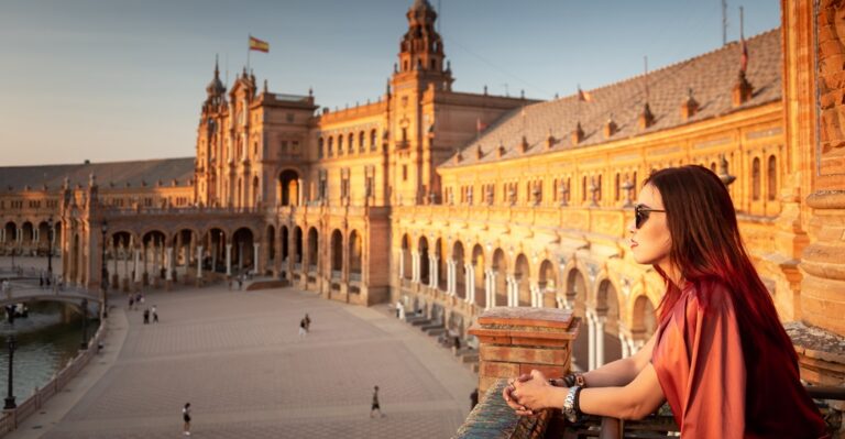 Smiling woman looking out from a terrace and thinking about the best ways to learn Spanish