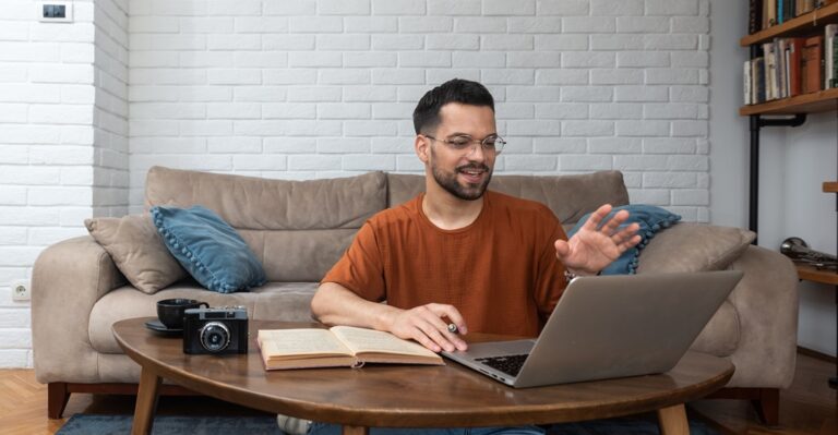 young man at his laptop, discussing online how long does it take to learn spanish